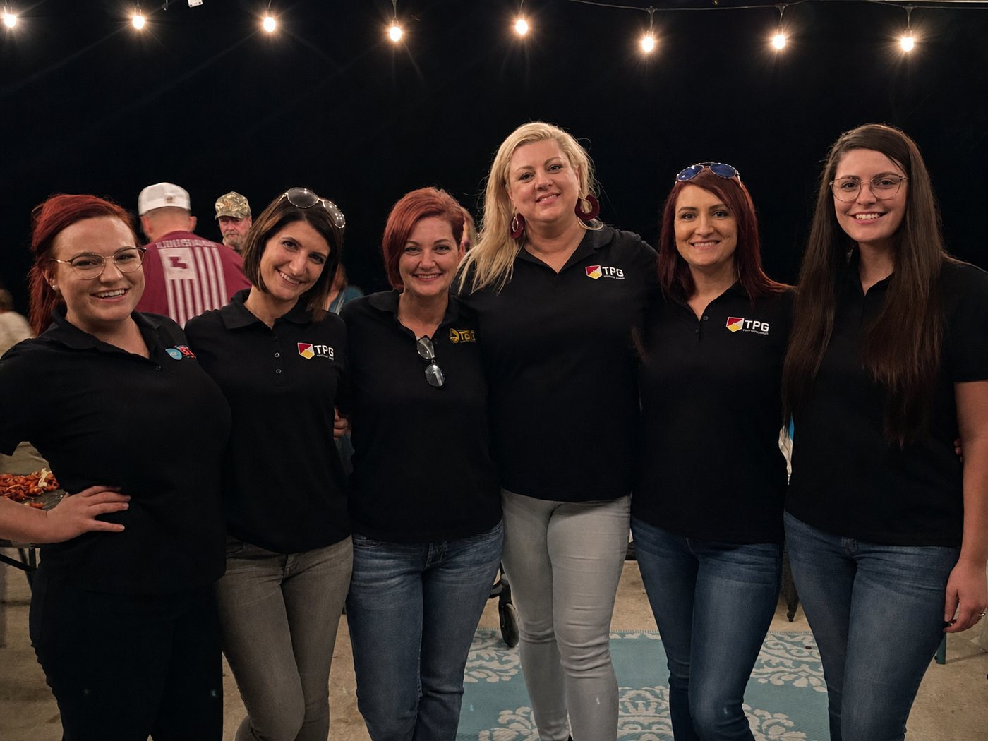 TPG team members in branded polos together at a company event
